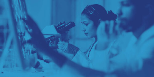 Female and male technicians in laboratory examining samples