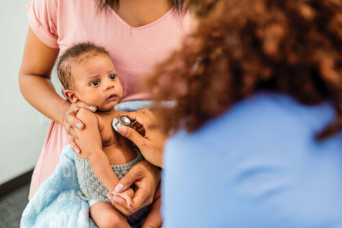 Doctor listening to baby's heartbeat with a stethoscope