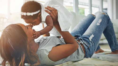 Black mother holding infant daughter