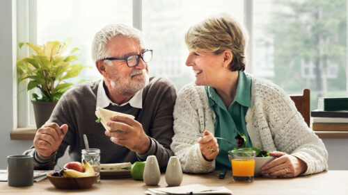 Senior couple having breakfast at home